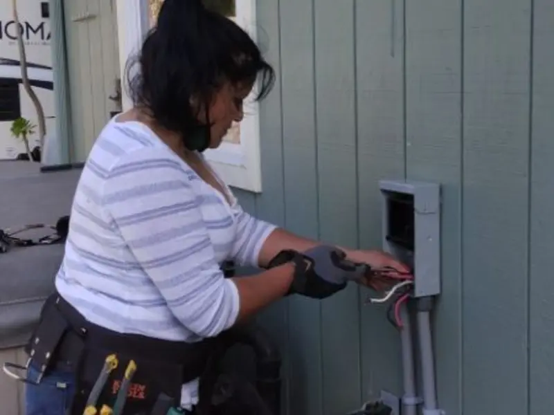 Licensed electrician wiring an exterior subpanel in Loxahatchee Groves